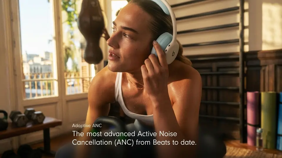 Person wearing Beats 360 headphones with Adaptive ANC during a gym workout