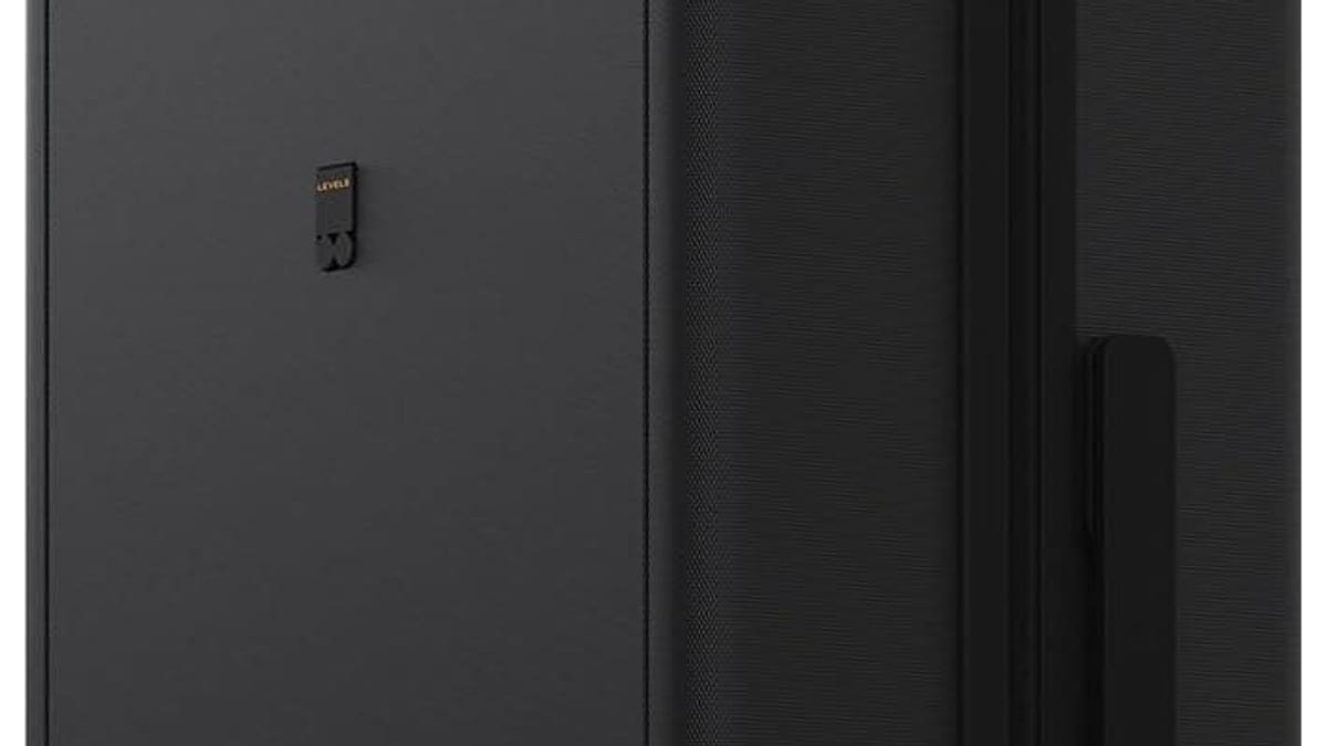 Carry-on suitcase next to airline size measuring box